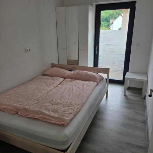 a bed with two pillows on it in a bedroom at ALLGÄU SONNENSEITE am ALPSEE -BERGE-SKI in Immenstadt im Allgäu