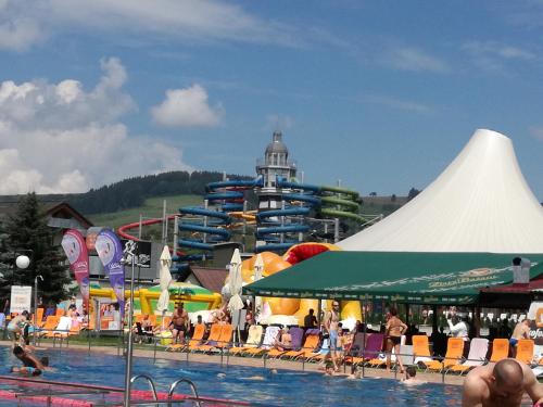 a water park with a pool and a water slide at Luxury Apartment in Bešeňová
