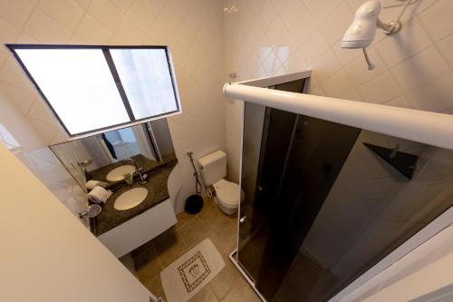 a small bathroom with a toilet and a window at Breeze Hotel in Natal