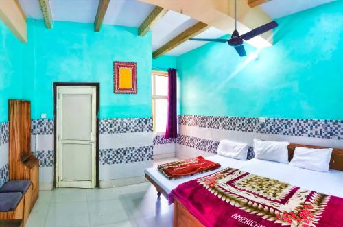 a bedroom with a bed with a blue wall at Hotel NAR NARAYANA in Chutwāpīpal