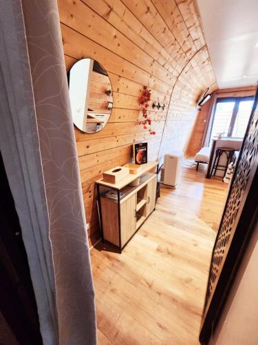a room with a wooden ceiling and a room with a desk at L'éco-maison tout confort in Puisserguier