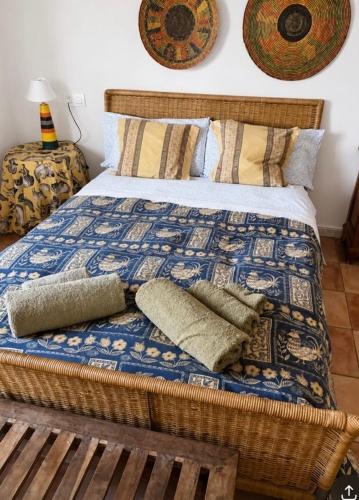a bedroom with a bed with a blanket and pillows at Cortijo Zalamea in Zalamea la Real