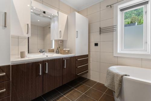 a bathroom with a sink and a tub and a window at Hus i Stryn med utsikt in Stryn