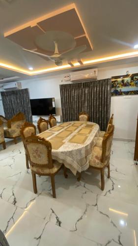 a dining room with a table and chairs on a marble floor at Vihari Luxury Resort in Alamanda
