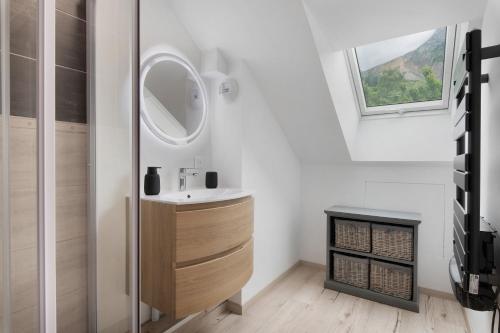 a bathroom with a sink and a mirror at Duplex la source Amelie in Saint-Pancrasse