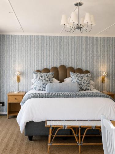 a bedroom with a large bed and a chandelier at 24 Bergview Road apartment in Hilton