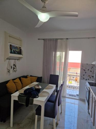 a living room with a table and a couch at Iraklia Pearl in Nea Irakleia