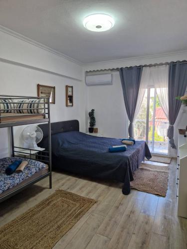 a bedroom with a bed and a bunk bed at Iraklia Pearl in Nea Irakleia