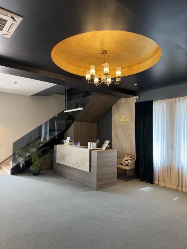 a lobby with a reception desk and a circular ceiling at Hotel Kazak Club in Chişinău