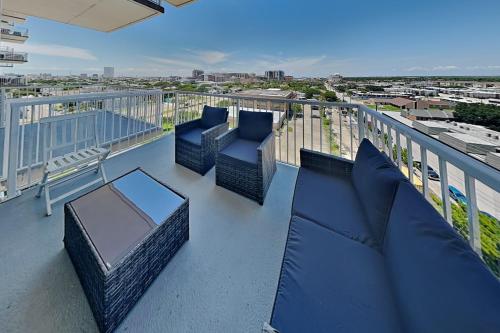 a balcony with chairs and tables on a roof at Emerald 705 in Galveston