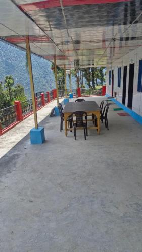 a group of tables and chairs in a building at The Captain's Quarters in Ukhimath