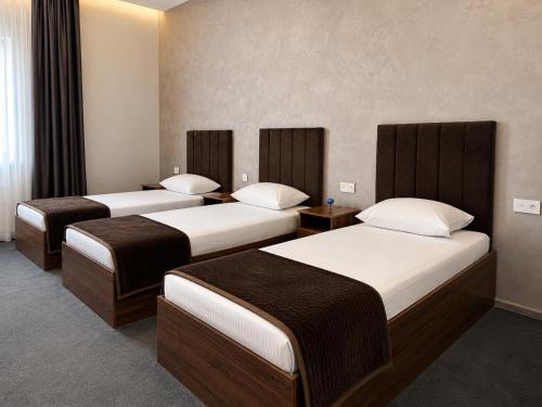 a hotel room with two beds in a room at Arena Hotel Tartar in Terter