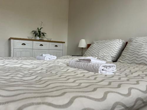a bedroom with a bed with towels on it at Linden House in Sklené