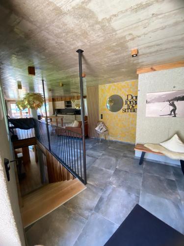 a room with a staircase and a living room at Appartement Hauser in Zell am Ziller