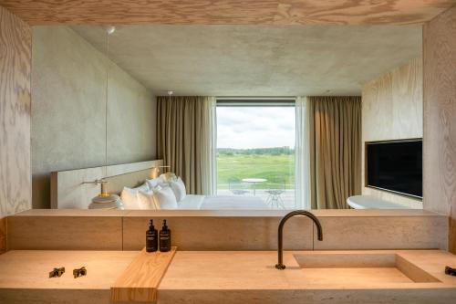 a bedroom with a bed and a large window at Radisson Collection The National Hotel, Brussels in Zaventem