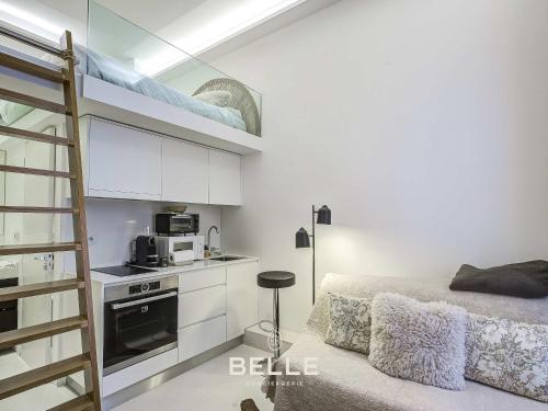 a bedroom with a bunk bed with a microwave and a kitchen at Rocher - 3min Port Hercule - Casino in Monte Carlo