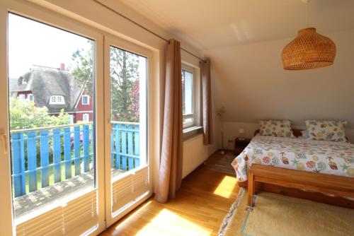 a bedroom with a bed and a large window at Ferienhaus Uli in Wustrow