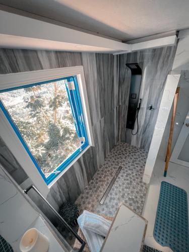 a small bathroom with a window and a shower at Private Oasis with Jacuzzi & Pool for Two in Ciales