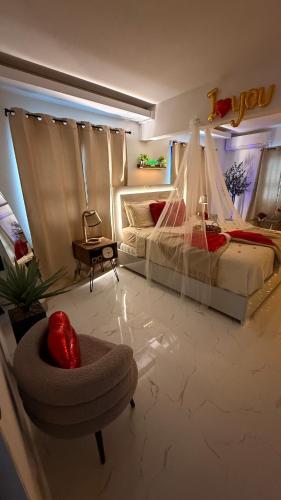 a bedroom with a bed and a chair and a table at Private Oasis with Jacuzzi & Pool for Two in Ciales