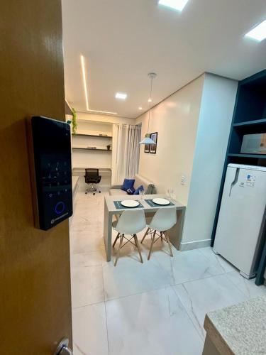 a kitchen and living room with a table and chairs at Studio Atalaia - C -308 - By Hospede Fácil in Brasília