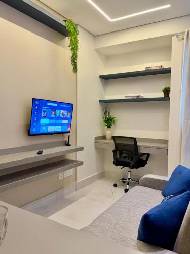 a living room with a tv and a couch and a chair at Studio Atalaia - C -308 - By Hospede Fácil in Brasília