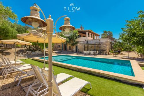 a villa with a swimming pool and a house at Villa Bandris by Slow Villas in Manacor