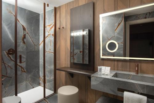 a bathroom with a sink and a shower at UNA Hotels Capotaormina in Taormina