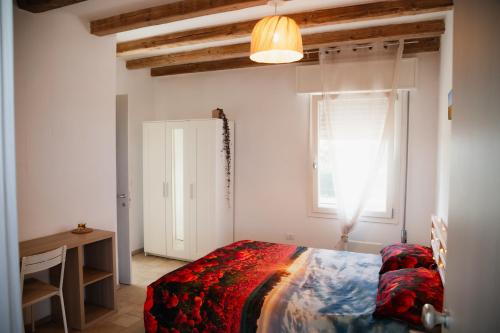 a bedroom with a bed and a window at Ca' Foega rooms in Chioggia