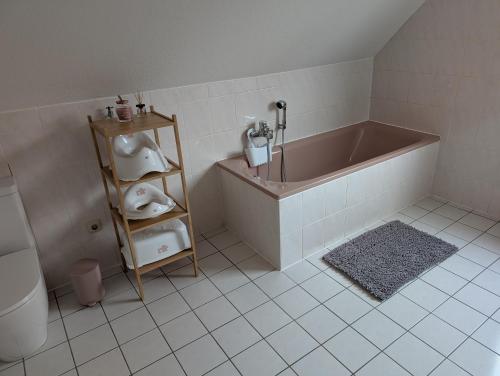 a bathroom with a tub and a toilet at Apartment am Park Anklam in Anklam