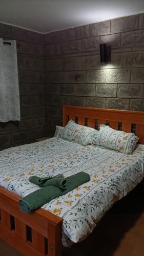 a bed with two green towels sitting on it at Propost place in Kijabe