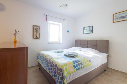 a bedroom with a bed with a colorful blanket on it at Green Oasis by the Sea in Koper