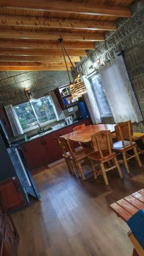 a dining room with a wooden table and chairs at Propost place in Kijabe