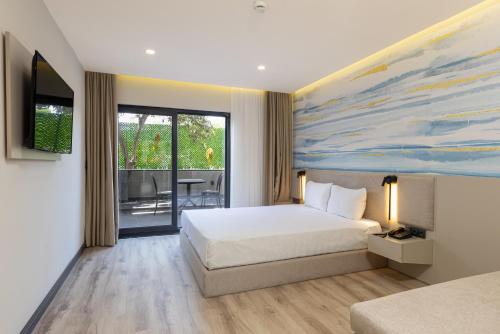 a hotel room with a bed and a painting on the wall at Fora Inn Lara in Antalya
