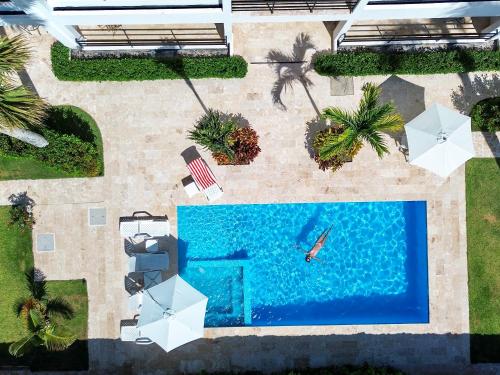 an overhead view of a pool with a person swimming at La Curadiña - Encuentro Surf Hotel in Cabarete