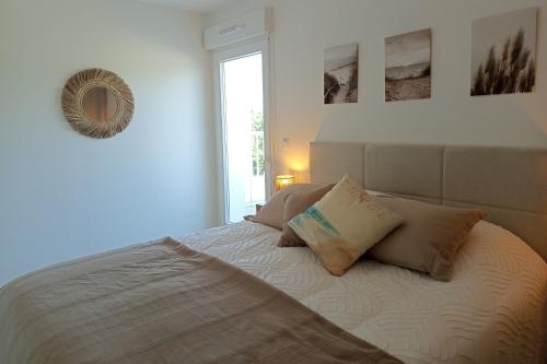 a bedroom with a bed with two pillows on it at Spacious and bright 125m2 apartment in Berck in Berck-sur-Mer