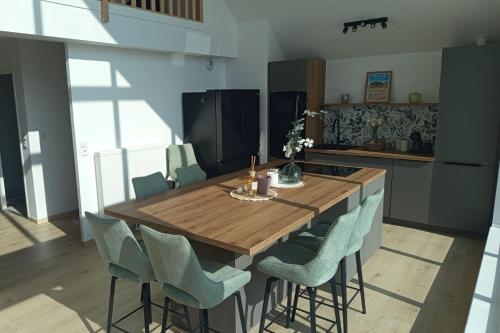 a kitchen with a wooden table and chairs at Spacious and bright 125m2 apartment in Berck in Berck-sur-Mer