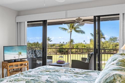 a bedroom with a bed and a view of the ocean at Keauhou Punahele#D-206 in Kailua-Kona