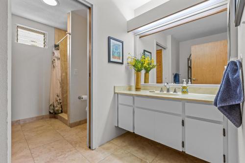 a bathroom with a sink and a mirror at Keauhou Punahele#D-206 in Kailua-Kona