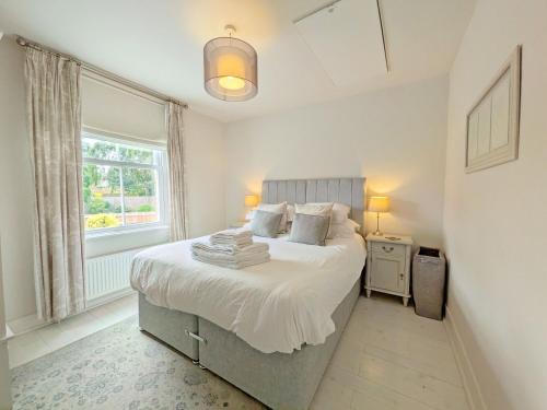 a bedroom with a bed and a window at Compass Cottage , Emsworth in Emsworth