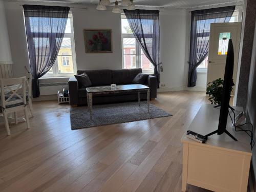 a living room with a couch and a table at Karja Apartment with sauna in Haapsalu