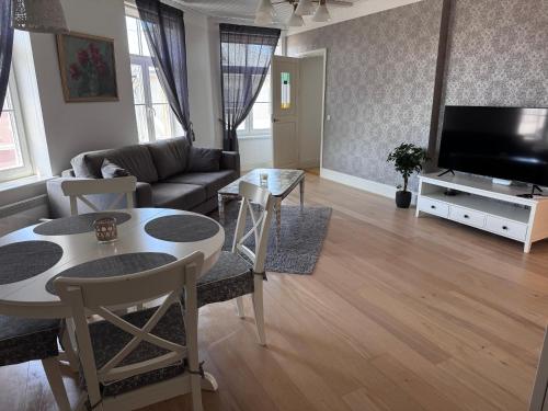 a living room with a couch and a table at Karja Apartment with sauna in Haapsalu