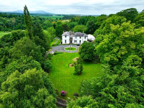 an aerial view of a house in the forest at Edinburgh Country Estate Rooms & Apartments in Gorebridge