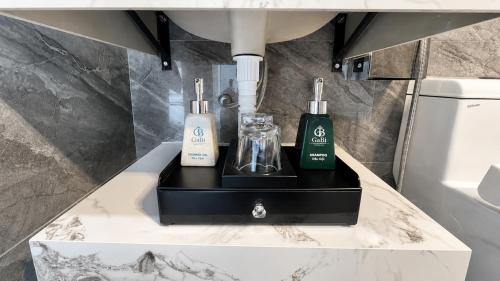 a bathroom with two soap bottles on a counter at Gabi Boutique Hotel in Mộc Châu