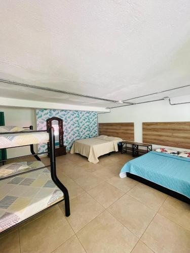 a room with two bunk beds in it at Hotel TIERRA NUEVA Campestre in La Vega