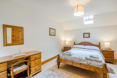 a bedroom with a wooden bed and a desk at 2 Bed in Denton oc-b42753 in Kenton