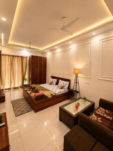 a living room with a bed and a couch at Darshana Studios# Couple Friendly in Noida