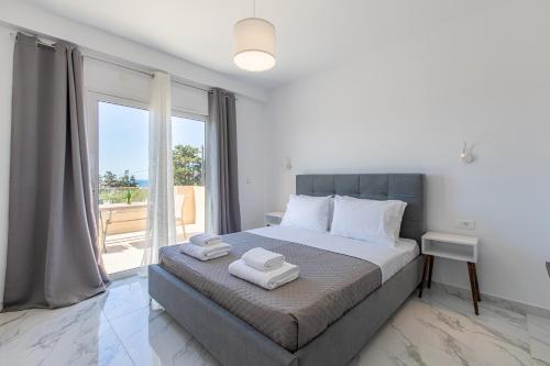 a bedroom with a bed with two towels on it at Casa Eda in Agia Marina Nea Kydonias