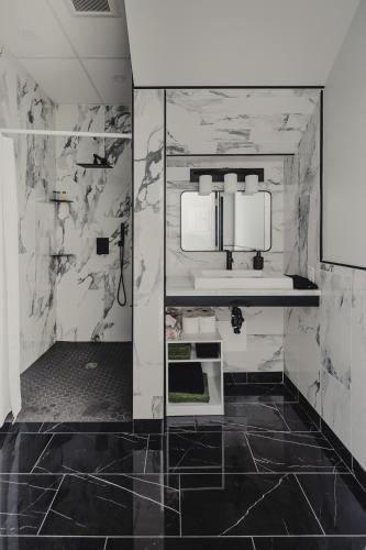 a bathroom with black and white marble walls at Falkenberg Business Centre and Suites in Botwood
