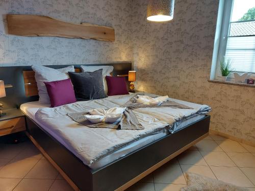 a bedroom with a large bed with towels on it at Eifel Dream Wildeiche in Fleringen