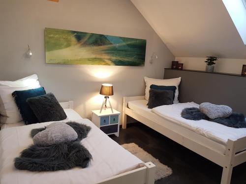 a room with two beds and a painting on the wall at Eifel Dream Ardennenblick in Kobscheid